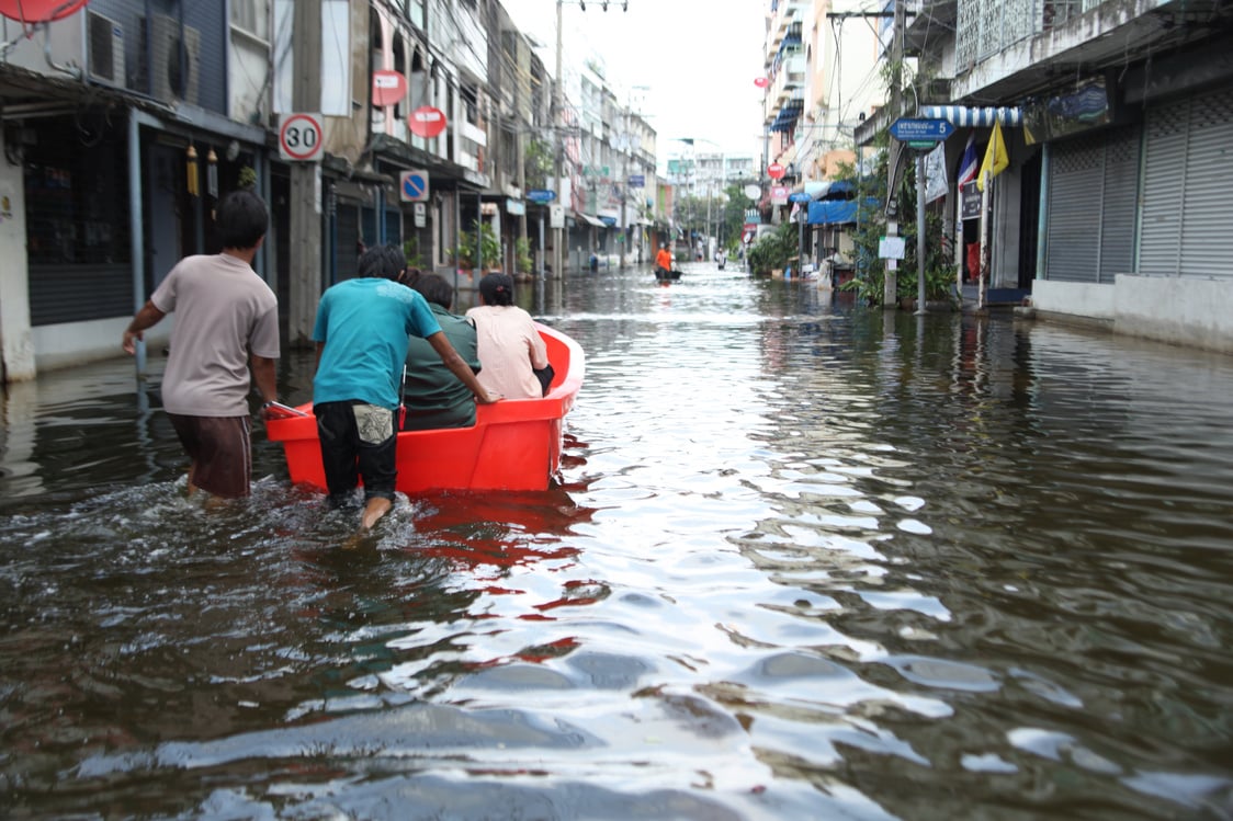 People on a Rescue Boat on a Flooded Streets